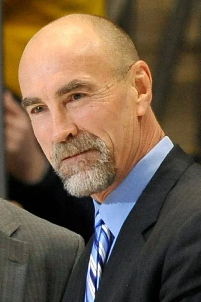 A man with a beard and mustache wearing a suit.