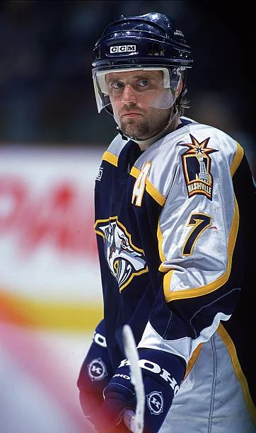 A hockey player in blue and white uniform.