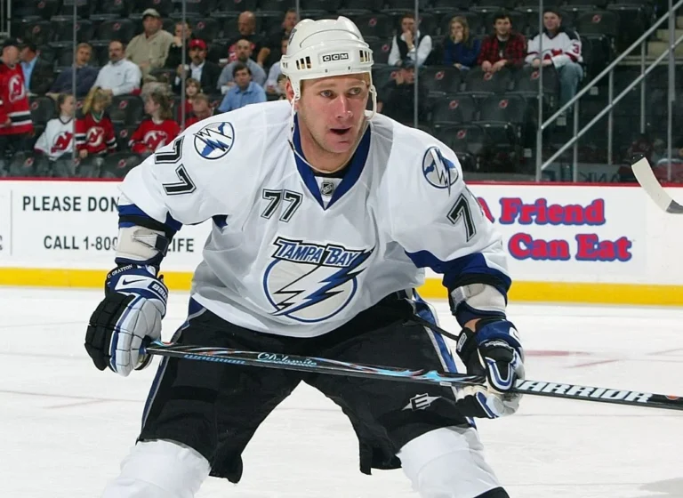 A hockey player is standing on the ice.
