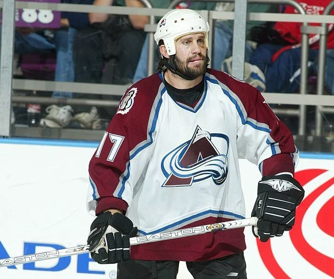 A hockey player in the middle of his team 's game.
