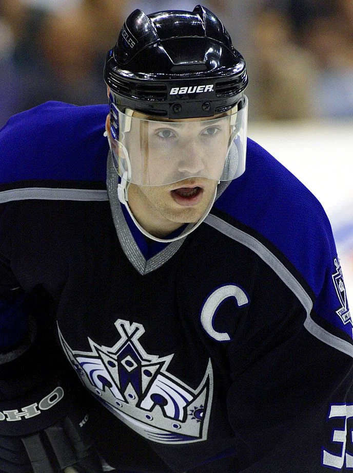 A hockey player in blue and black uniform.