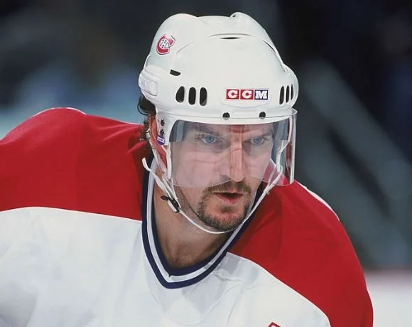 A close up of a hockey player wearing a helmet