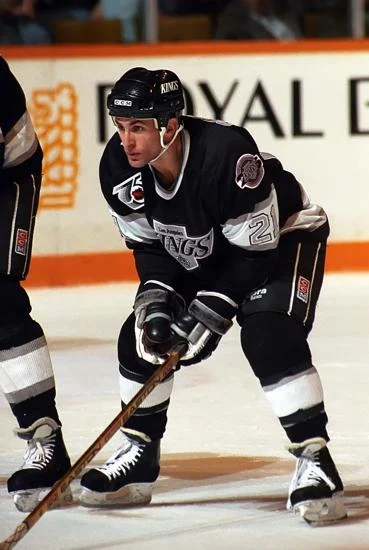 A hockey player is standing on the ice.