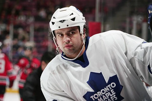 A hockey player wearing a white and blue uniform.