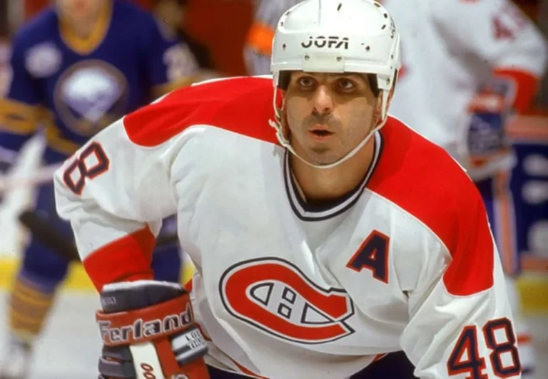A hockey player in white and red uniform.
